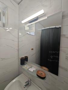 a white bathroom with a sink and a mirror at Hotel Lozite in Sozopol +143 photos