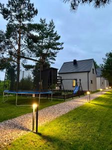 a park with a playground with a swing at Lobeliowe Domki in Chośnica