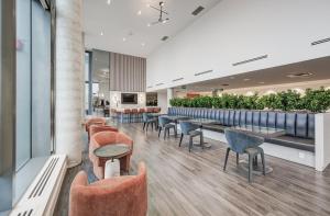 a restaurant with tables and chairs and a bar at Cozy Condo in Downtown KW in Kitchener