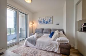 a bedroom with a large bed and a large window at Cozy Condo in Downtown KW in Kitchener