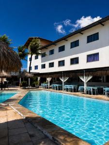 a swimming pool in front of a hotel at La Suite Praia Hotel in Caucaia