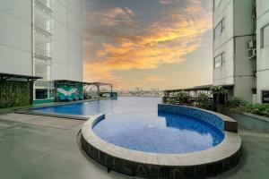 a large swimming pool in the middle of a building at ASTON Pluit Hotel & Residence in Jakarta
