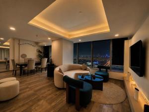 a living room with a couch and a table at Whispers above the city 2Bhk Centaurus Mall pool Gym City view in Islamabad
