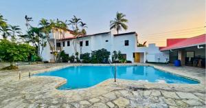 a swimming pool in front of a house at Costa lisa in Cabarete