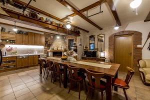 a kitchen with a large wooden table and chairs at Countryside family villa with pool Zmina in Donji Muć