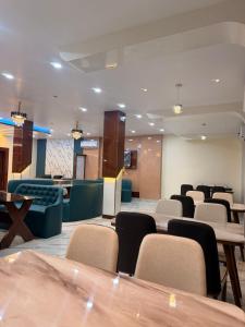 a waiting room with chairs and tables in a hospital at The Highway Haven in Silchar