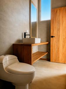 a bathroom with a toilet and a sink at La Cabaña de Iza in Canoas +43 photos