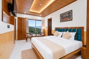 a bedroom with a large bed and a large window at The Dogri Boutique Cottage, Mashobra - Luxury Cottage with Scenic mountain view in Shimla