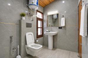 a bathroom with a toilet and a sink at The Dogri Boutique Cottage, Mashobra - Luxury Cottage with Scenic mountain view in Shimla +32 photos