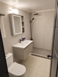 a bathroom with a sink and a toilet and a shower at New Star Hotel in Chu-sung +7 photos