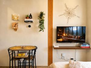a living room with a table and a couch at Peaceful Studio at The Median - City Skyline View, Short Walk to IT Park in Cebu City