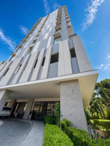 a tall building with a blue sky in the background at Peaceful Studio at The Median - City Skyline View, Short Walk to IT Park in Cebu City