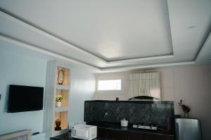 a living room with a flat screen tv on a ceiling at Kathmandu Mountain view Studio in Bālāju