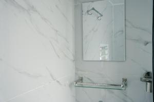 a bathroom with a mirror and a sink at Kathmandu Mountain view Studio in Bālāju +16 photos