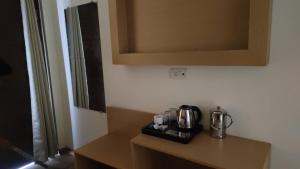 a kitchen counter with a coffee maker on it at JHS Kundli in Sonīpat