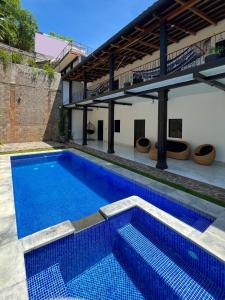 a swimming pool in front of a house at La Casona Suchitoto in Suchitoto