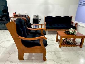 a living room with a chair and a couch at La Casona Suchitoto in Suchitoto
