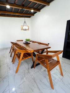 a wooden table and chairs in a room at La Casona Suchitoto in Suchitoto