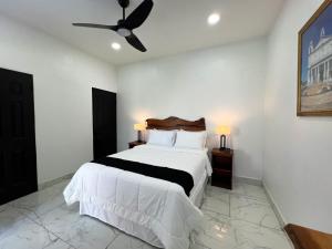 a bedroom with a bed and a ceiling fan at La Casona Suchitoto in Suchitoto +33 photos