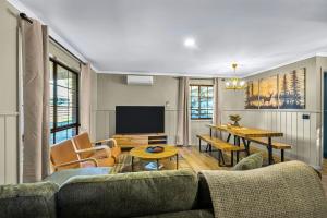 a living room with a couch and a table at Plum Pines Bright in Bright
