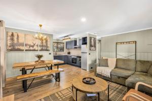 a living room with a couch and a table at Plum Pines Bright in Bright