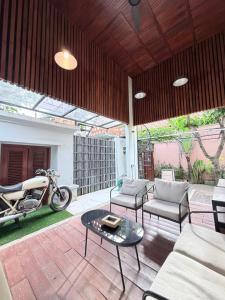 a living room with a motorcycle parked on a patio at Sutji living in Sanur