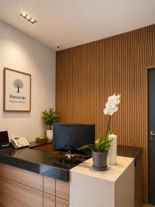 an office with a desk with a computer on it at Hotel Habitat San Antonio in Cali