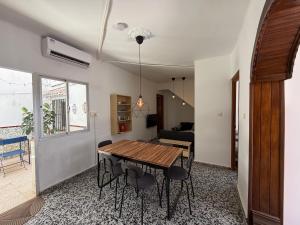 a dining room with a wooden table and chairs at Casa Hjort in Nerja