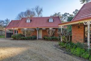 a brick house with a red roof at Plum Pines Bright in Bright