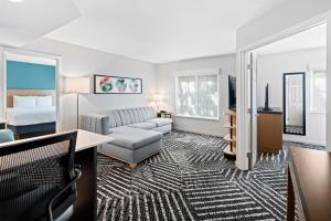 a hotel room with a bed and a living room at Hyatt House Boston/Burlington in Burlington