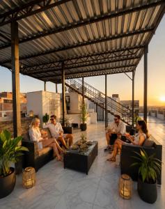 a group of people sitting on a roof at Families Pyramids view - Rooftop in Cairo