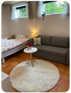 a living room with a couch and a table at Skøn perle midt i naturen in Munke Bjergby
