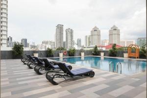 a row of chaise lounges on the roof of a building at Newly Renovated - Days Inn by Wyndham Singapore Novena in Singapore