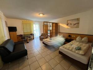 a living room with two beds and a couch at Apartmenthaus Home24 in Chemnitz