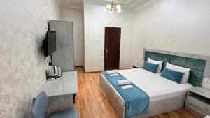 a bedroom with a large bed and a television at Art inn hotel in Tashkent