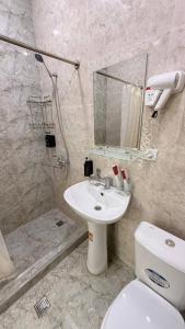 a bathroom with a toilet and a sink and a shower at Art inn hotel in Tashkent +32 photos