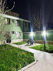 a couple of lights on a building at night at Art inn hotel in Tashkent