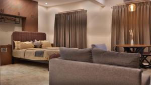 a bedroom with a bed and a couch at Aadvik Luxury Farmstay in Antarasante +65 photos
