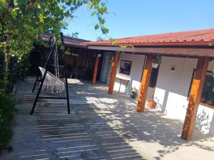 a house with a swing in front of it at Casa Micu in Corbu