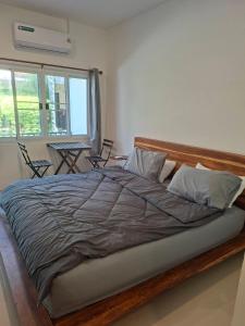 a bedroom with a large bed with a wooden frame at @888byChefKong in Ko Tao