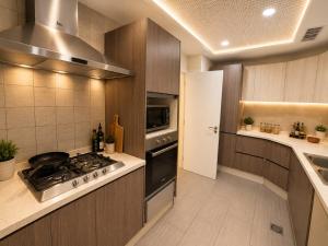 a kitchen with a stove and a sink at Whispers above the city 2Bhk Centaurus Mall pool Gym City view in Islamabad