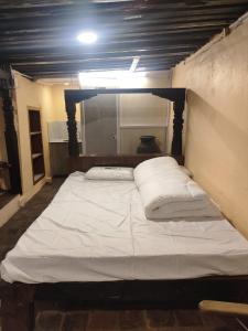 a bedroom with a large bed in a room at Sanjhyā Durbar Homestay in Bhaktapur