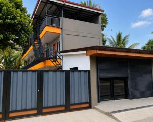 a house with a balcony on top of it at Casa Amul in Tigbawan