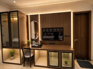 a hotel room with a desk and a mirror at Hotel Next View Amritsar # Pool # Parking # Family Hotel # Best choice for Tourists in Amritsar
