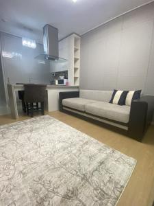 a living room with a couch and a piano at Wh in HighVill in Astana