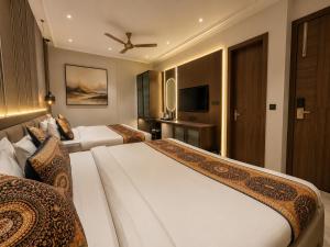 a hotel room with two beds and a television at Hotel Next View Amritsar # Pool # Parking # Family Hotel # Best choice for Tourists in Amritsar