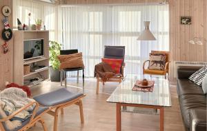 a living room with a couch and chairs at Nice Home In Grenaa With Sauna in Grenå +10 photos