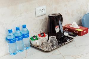 a tray with bottles of water on a counter at Art inn hotel in Tashkent