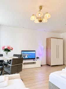 a living room with a television and a table at Hostel am Rhein - Nierstein in Nierstein