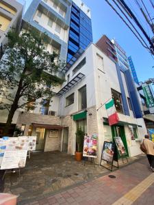 a building with signs in front of it at 高田馬場 Yoko hotel shinnjuku, shinokubo 10 people stay, big room in Tokyo